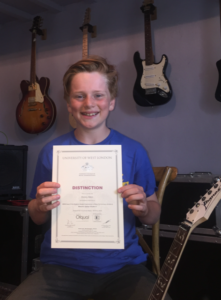 Guitar grade six distinction for Henry.